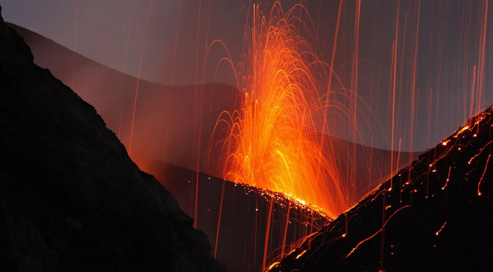 Lava fountains from Stromboli's crater terrace at dusk