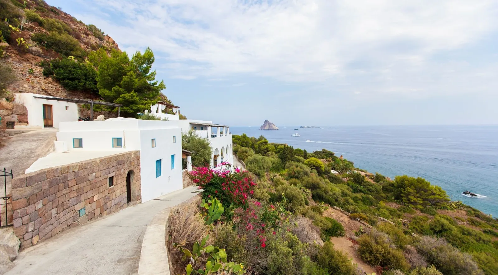 Whitewashed island houses on a lane above the sea