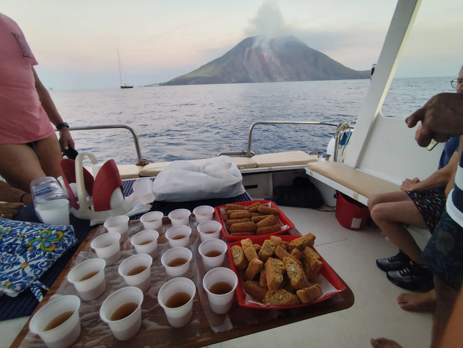 Snacks and drinks laid out on deck with Stromboli ahead