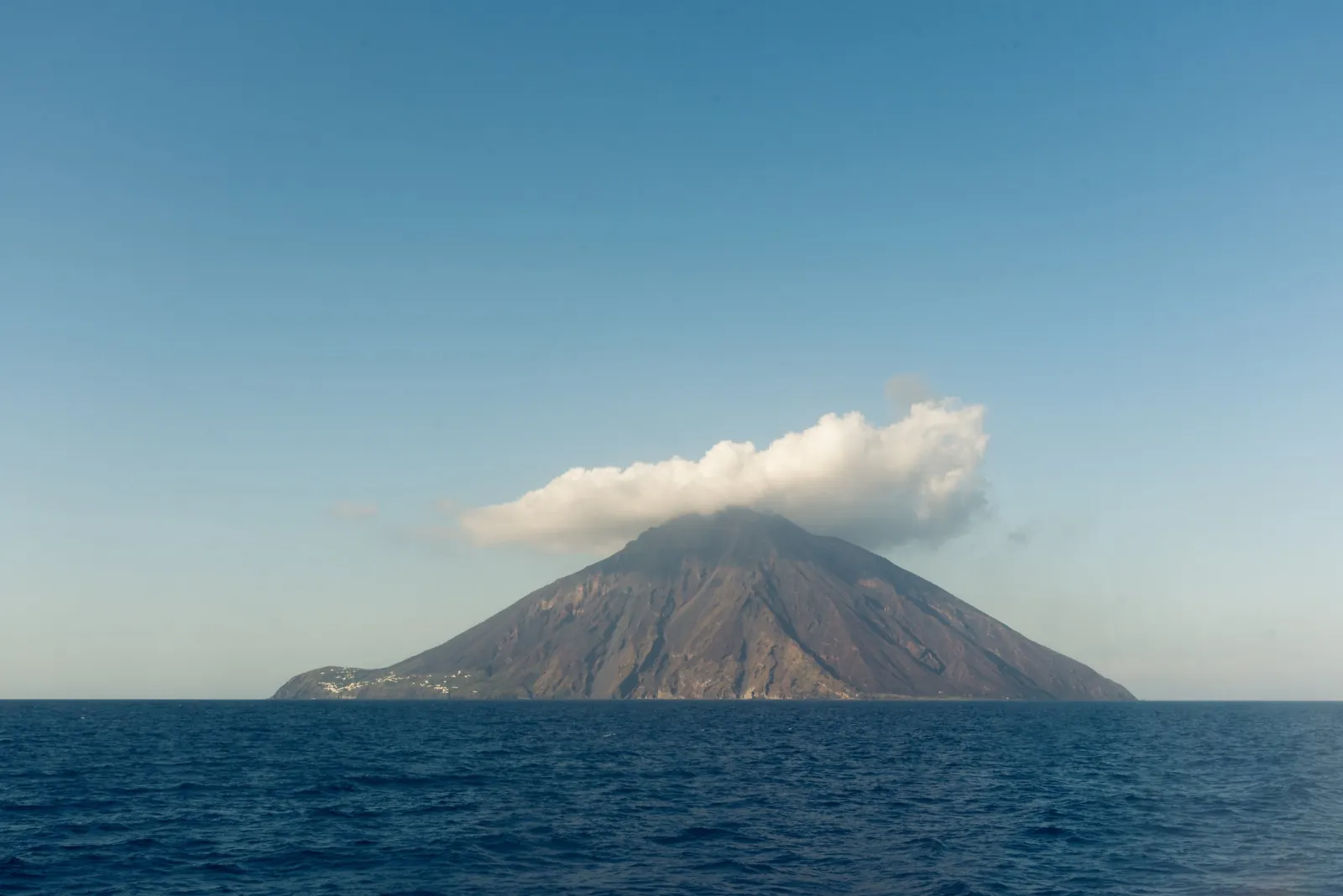 Stromboli with a cloud over its summit, seen from the sea