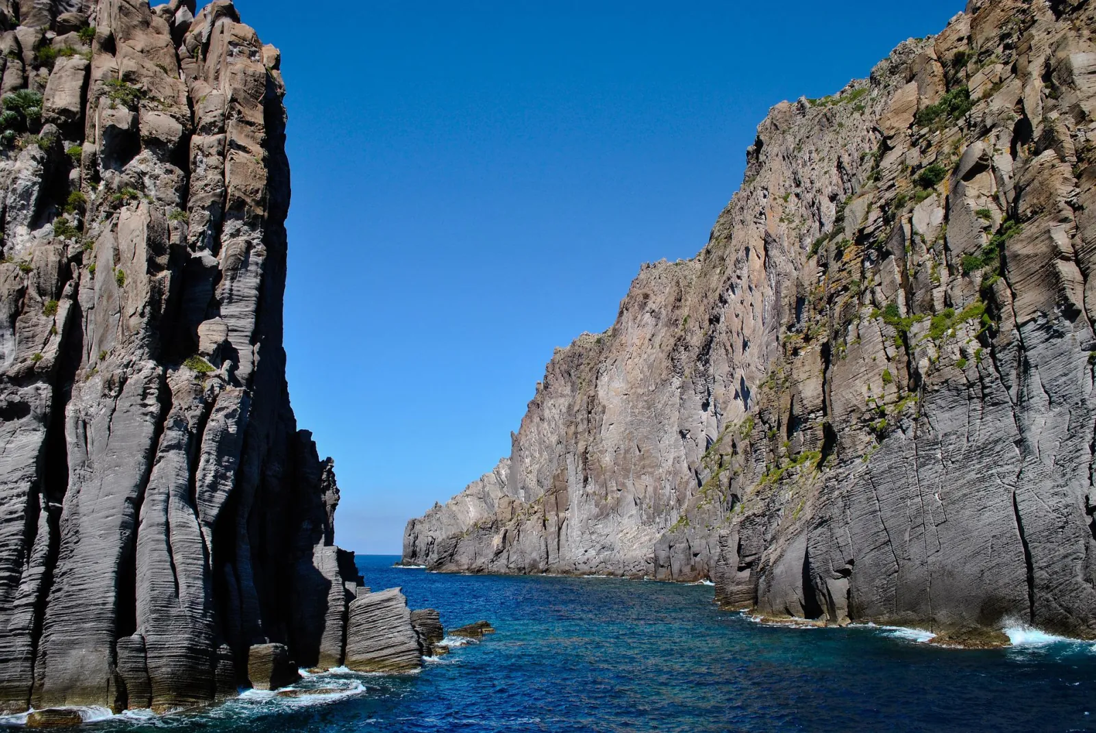 Tall sea cliffs of dark volcanic rock