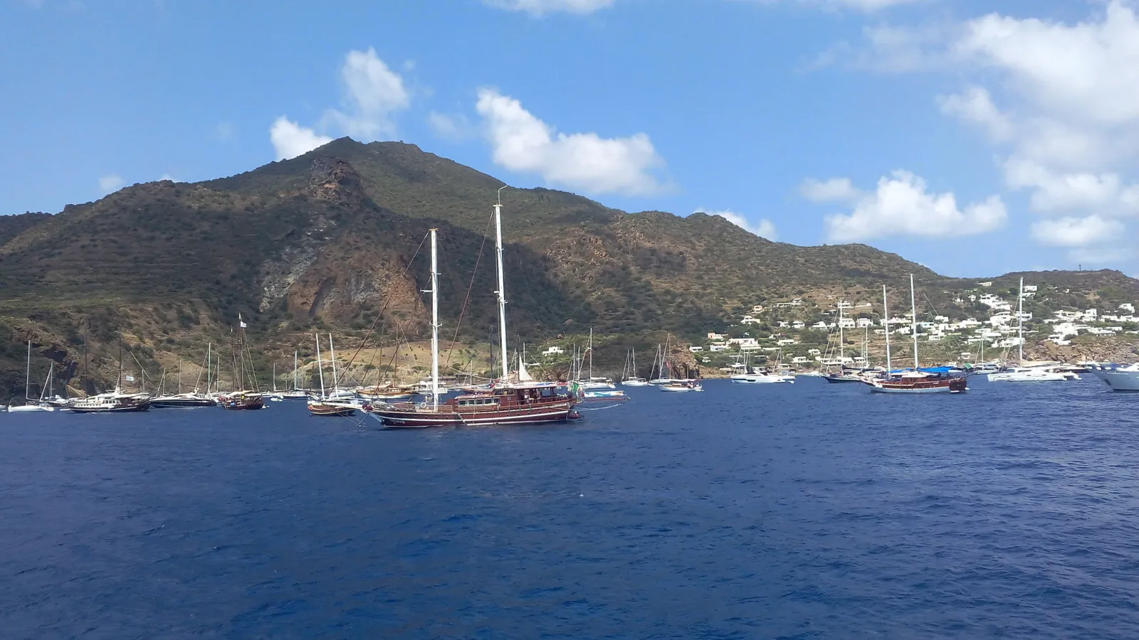 Yachts in the bay below the white houses of San Pietro on Panarea