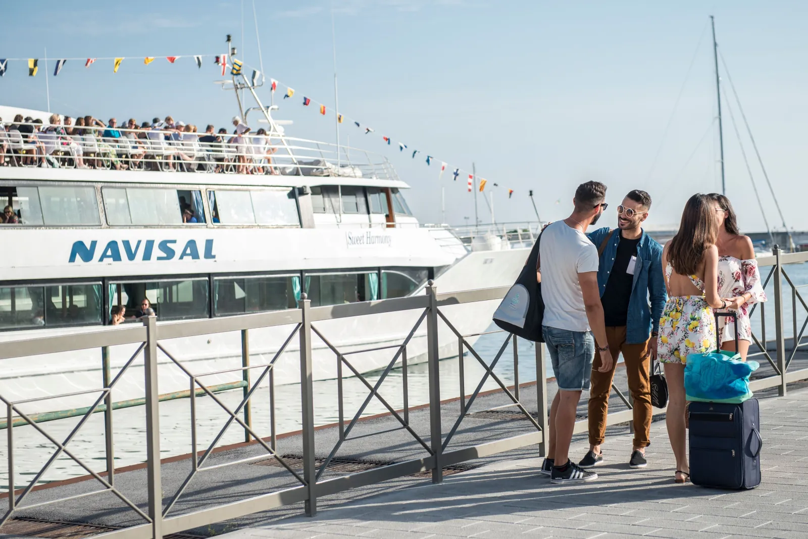 Passengers walking to the Navisal boat on the quay