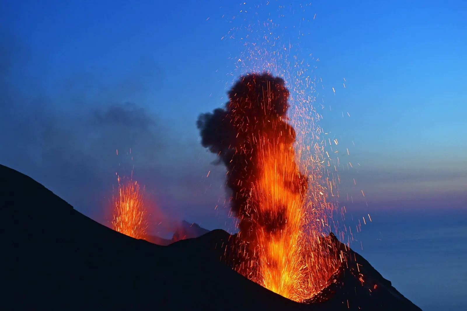 An explosion from Stromboli's summit craters at dusk