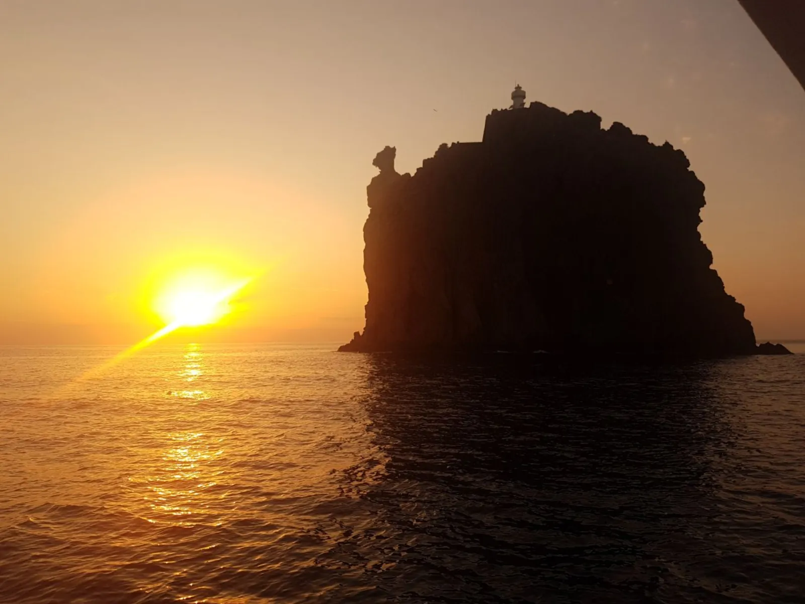 The sun setting behind Strombolicchio