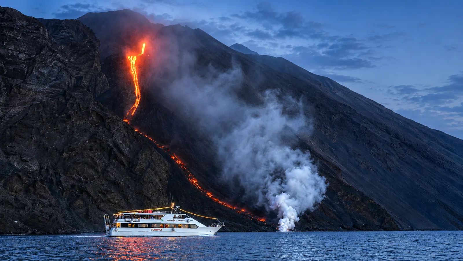 Comerci boat below the lava flow on the Sciara del Fuoco at dusk
