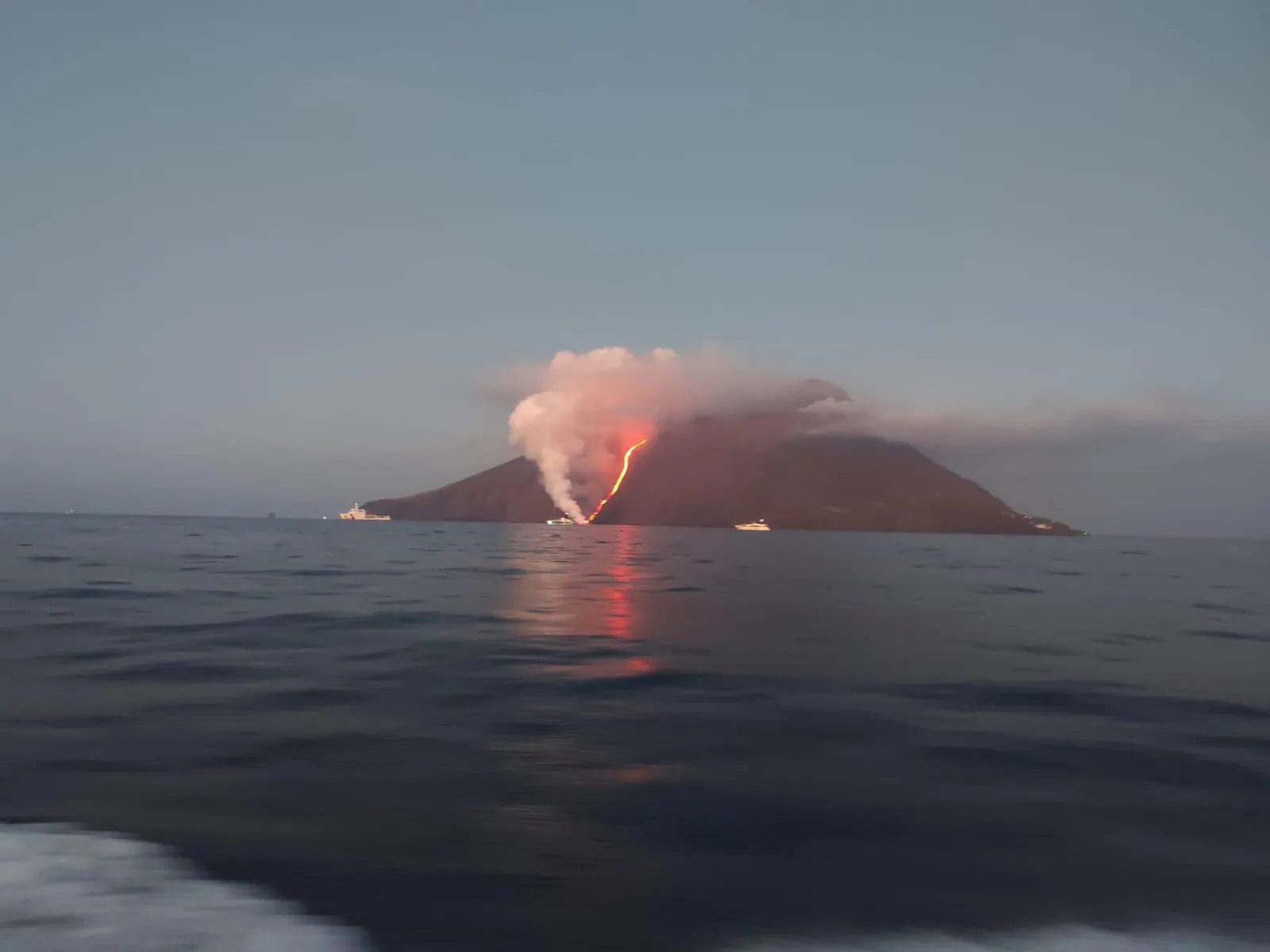 Stromboli's plume over a calm grey sea