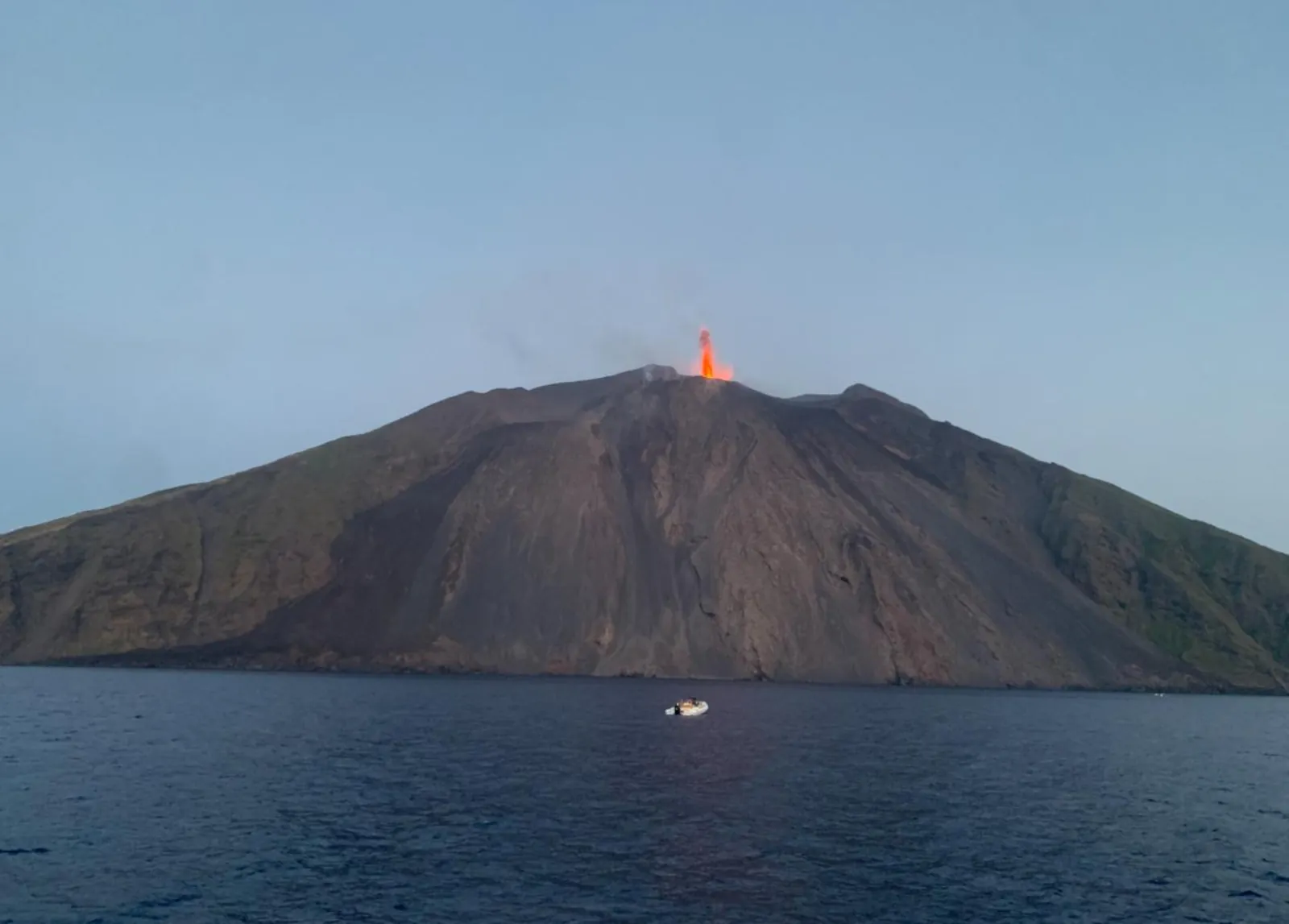 Stromboli at dusk with a glow at the summit