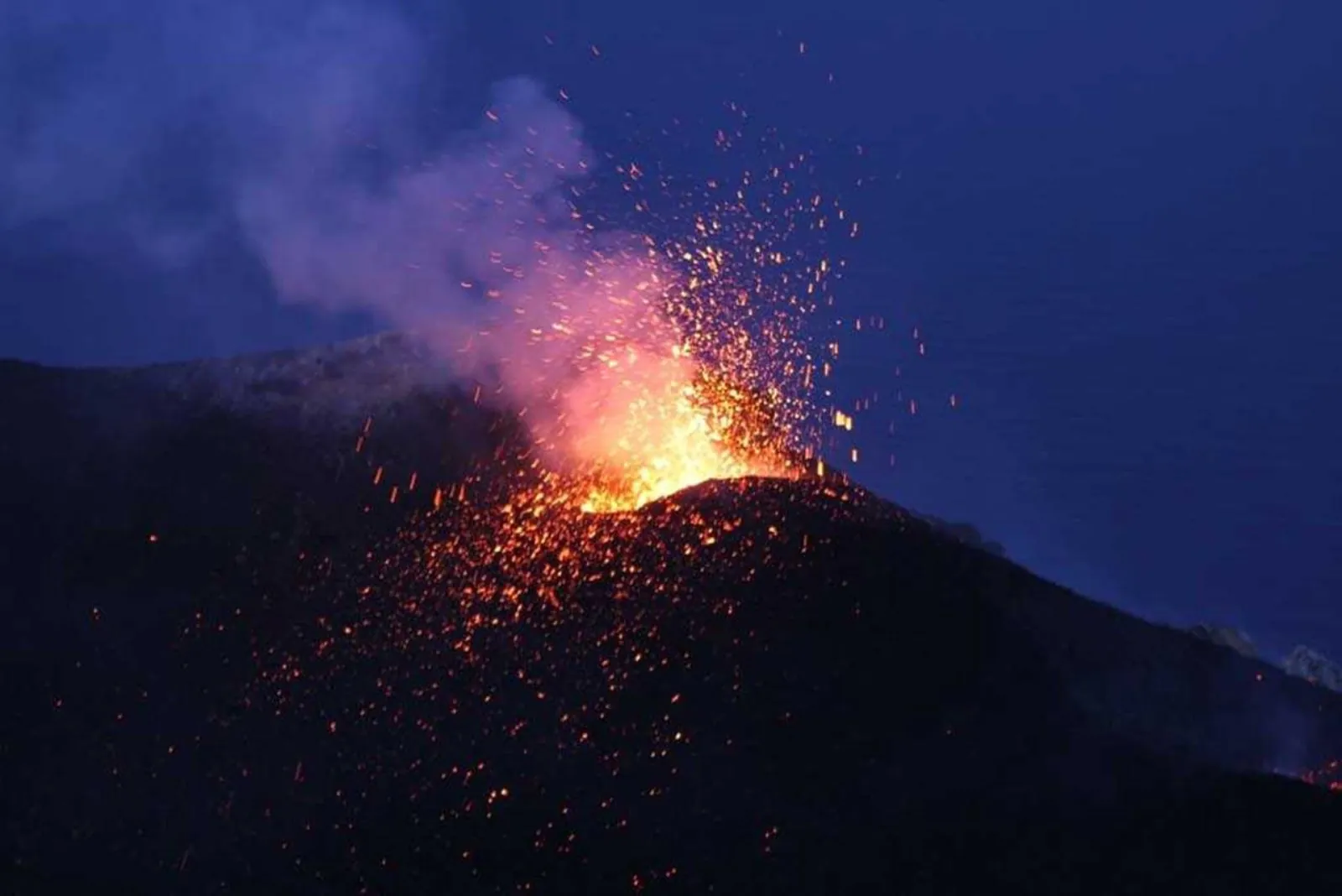 An explosion from the crater terrace at blue hour
