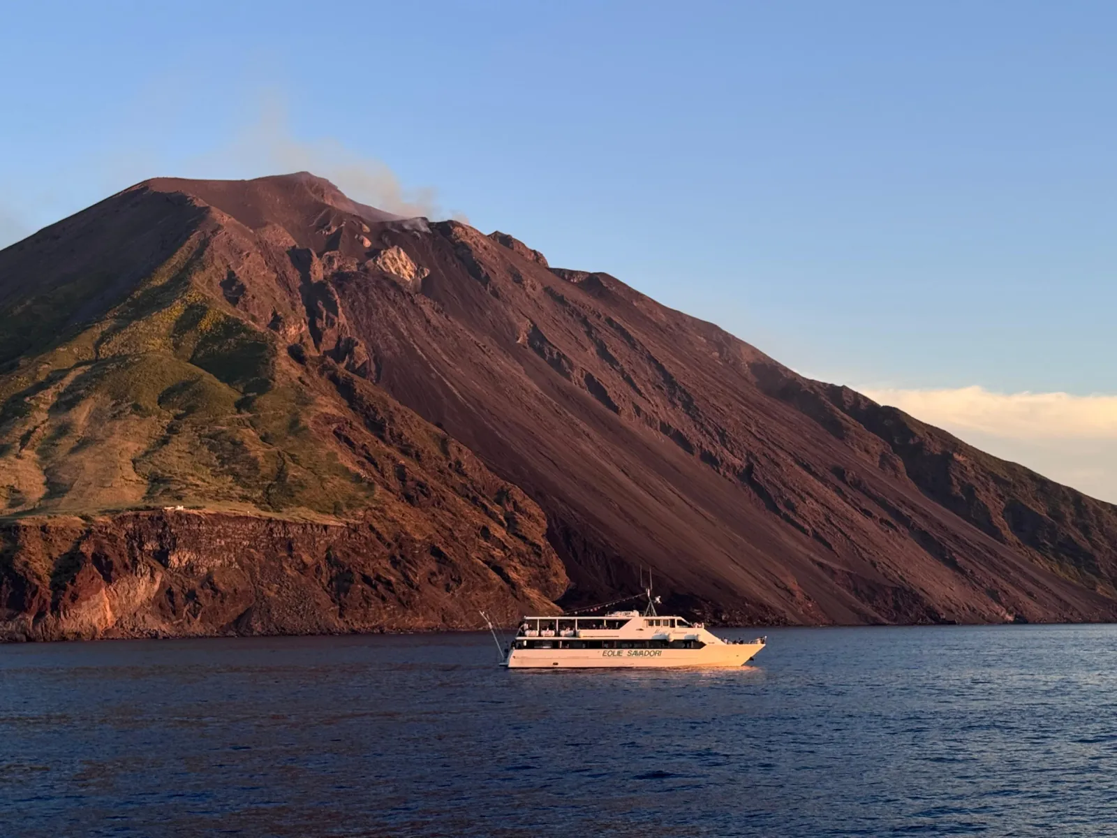 Savadori boat below the red-brown flank of Stromboli