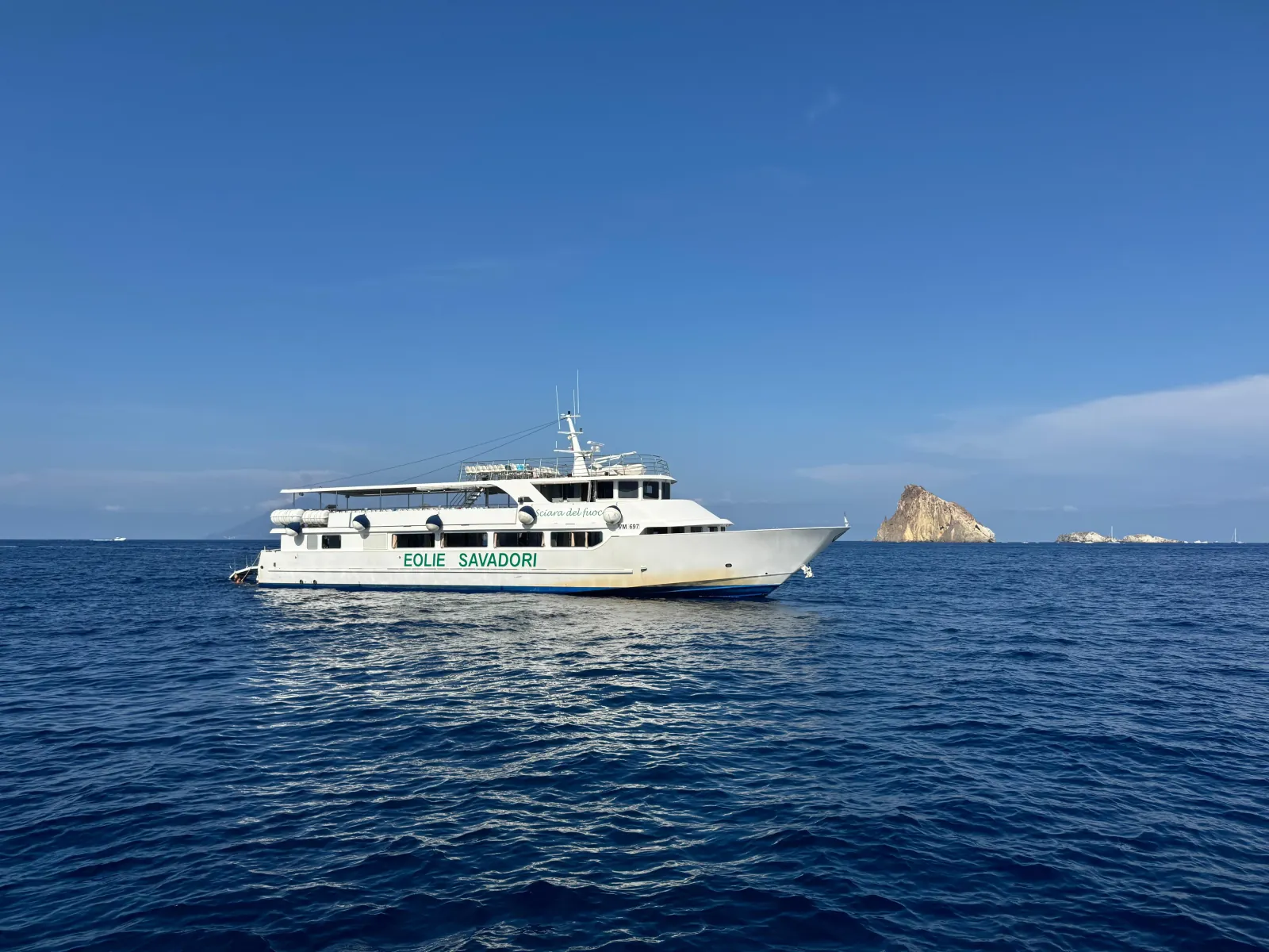Savadori boat at sea with Strombolicchio behind